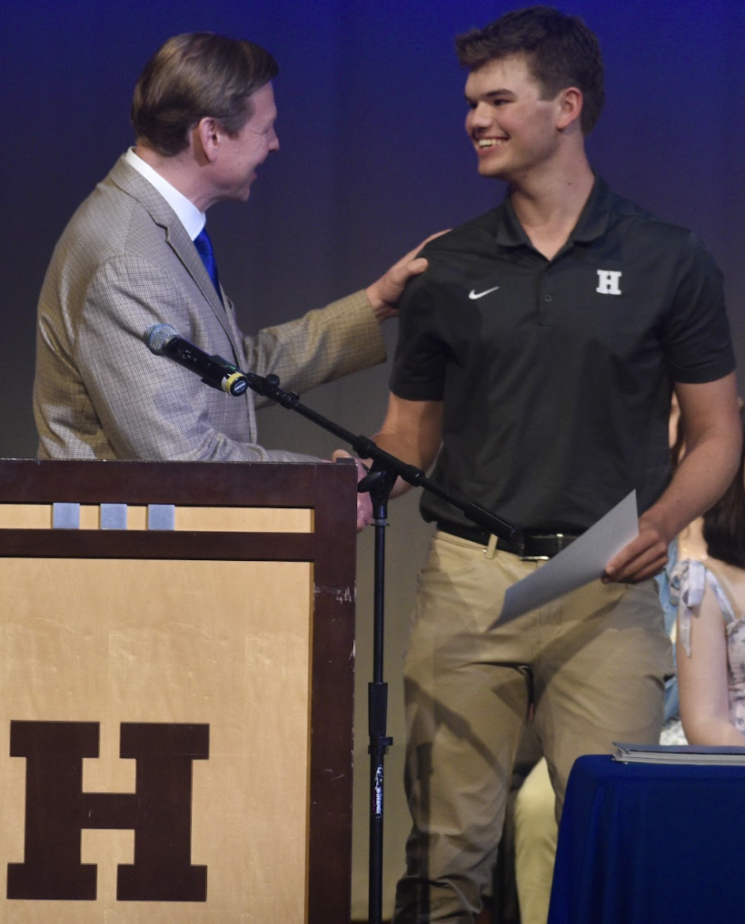 Brennan Bucher (12) smiles as he’s congratulated after receiving his senior award. 
